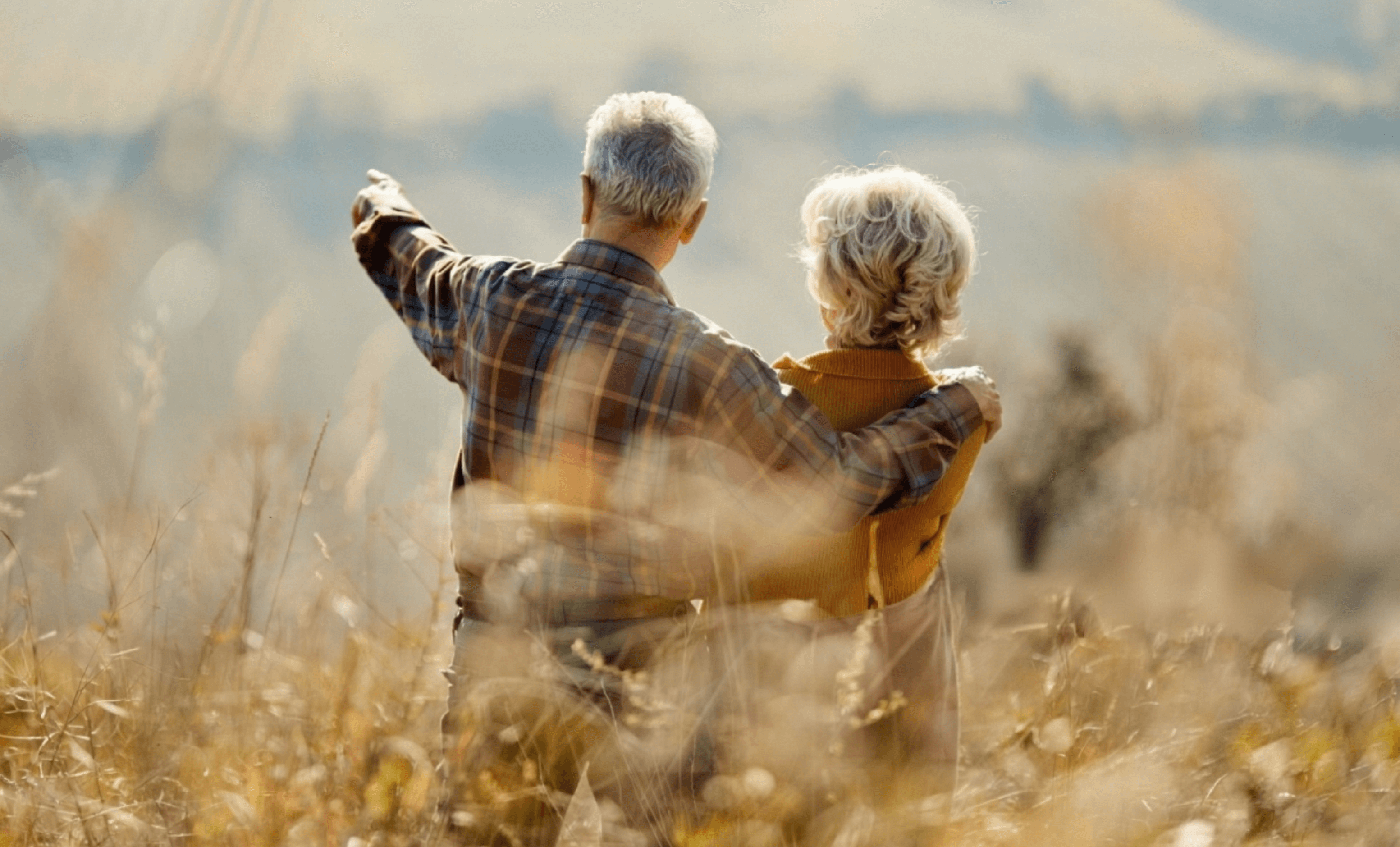 A senior couple looking out at a valley