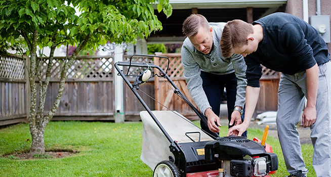 teen helping mow lawn