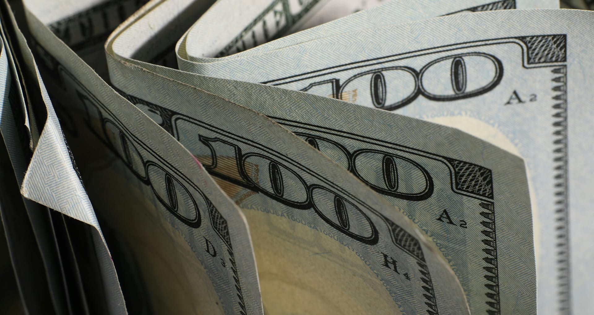 a closeup of folded $100 bills