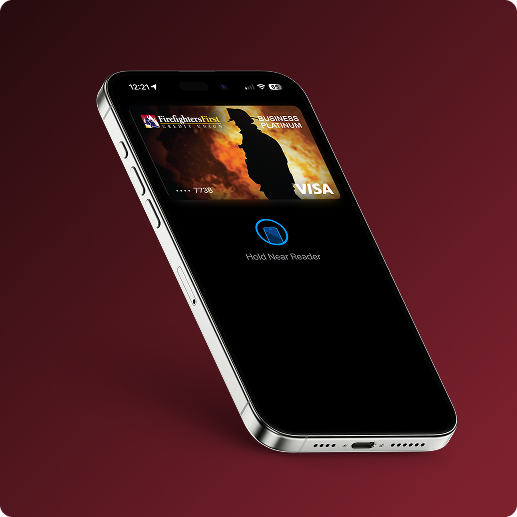 A iPhone laying on a red gradient background, with a photo of a Firefighters First credit card on the screen, and an icon that directs the user to 