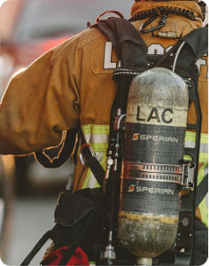cropped photo of a fireman in full gear walking away from the camera