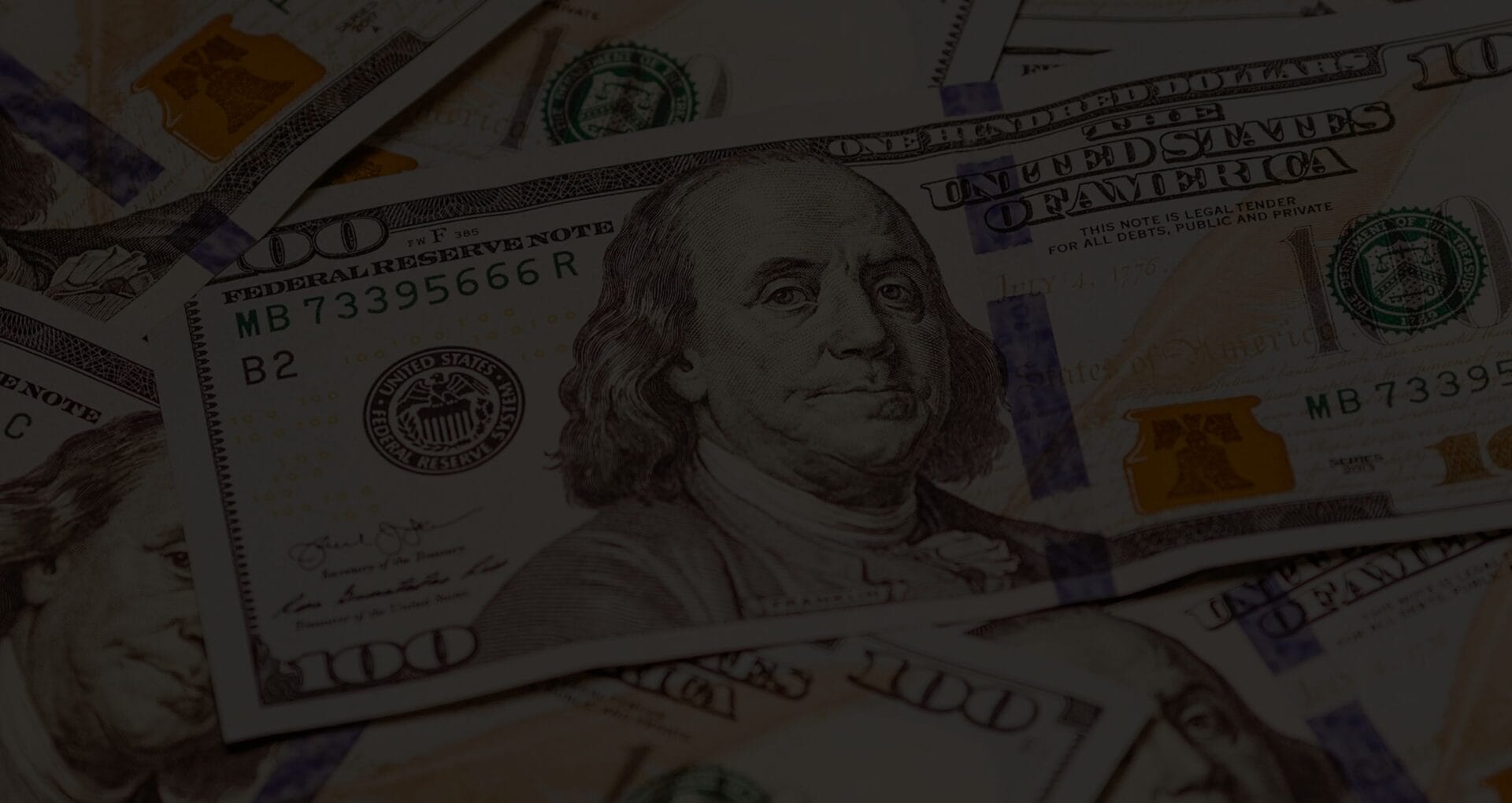 Close-up of scattered US hundred dollar bills