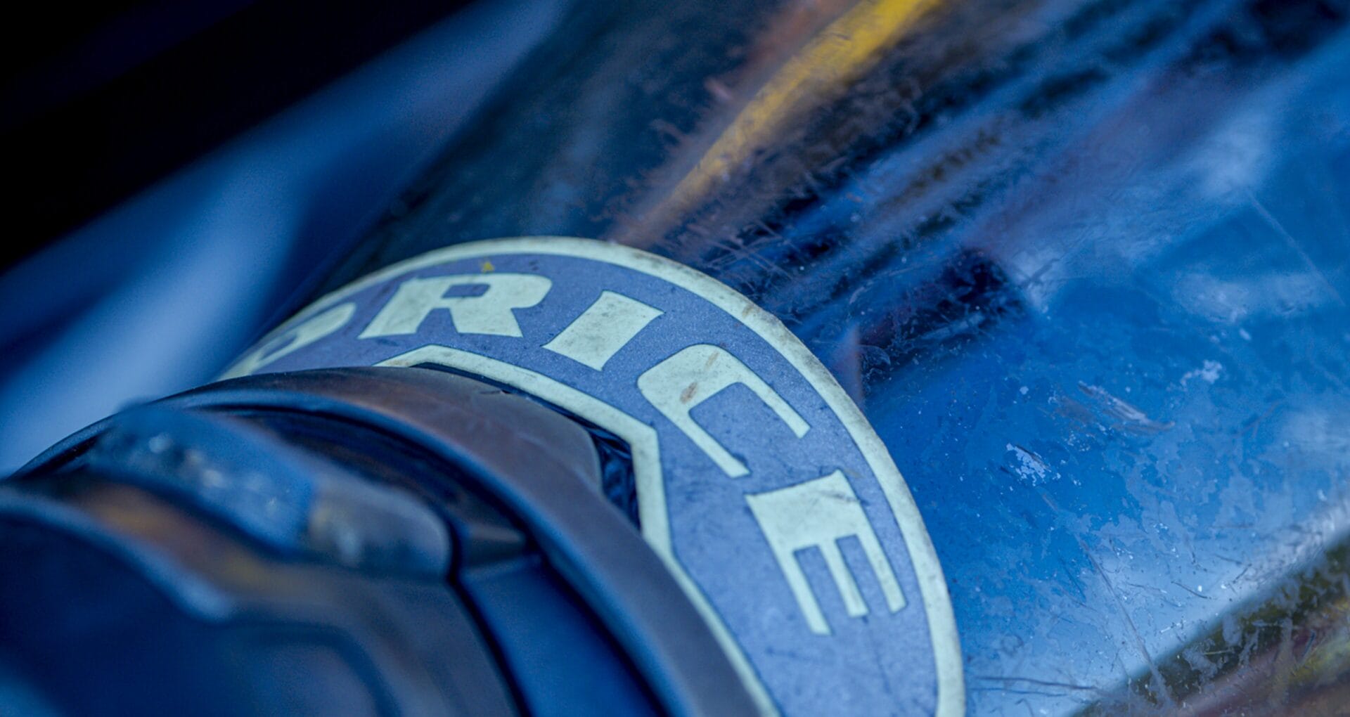 Close-up of a worn blue mask with a name badge label