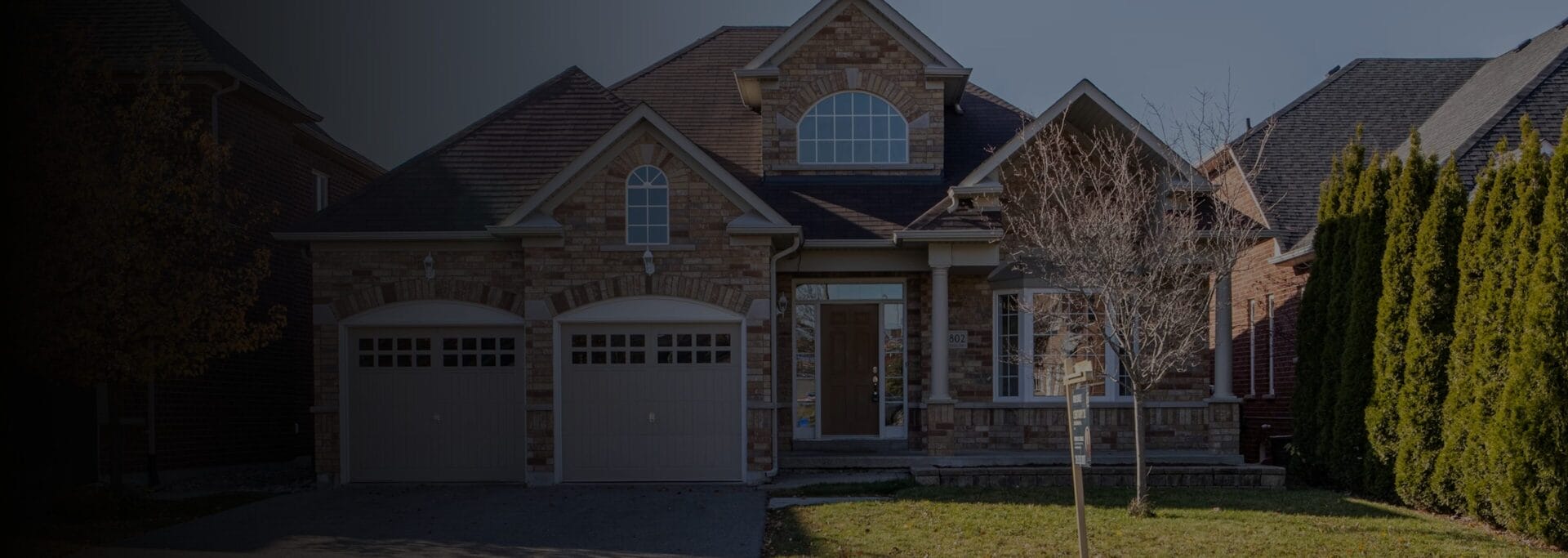 Large two-story brick house viewed from the front.
