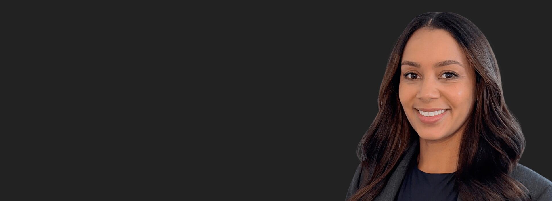 Claudia Carr in a dark blazer against a dark background