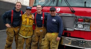 fire fighters in front of their car