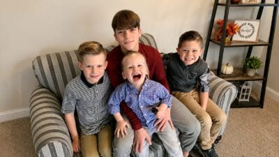 happy siblings on a sofa