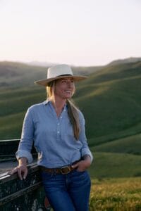 a woman standing by her truck