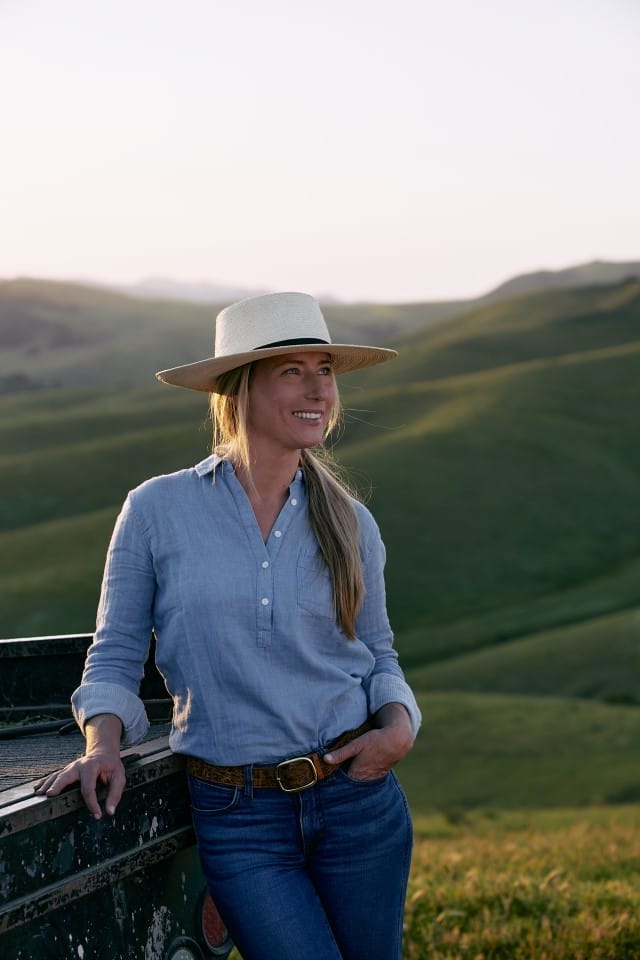 a woman standing by her truck