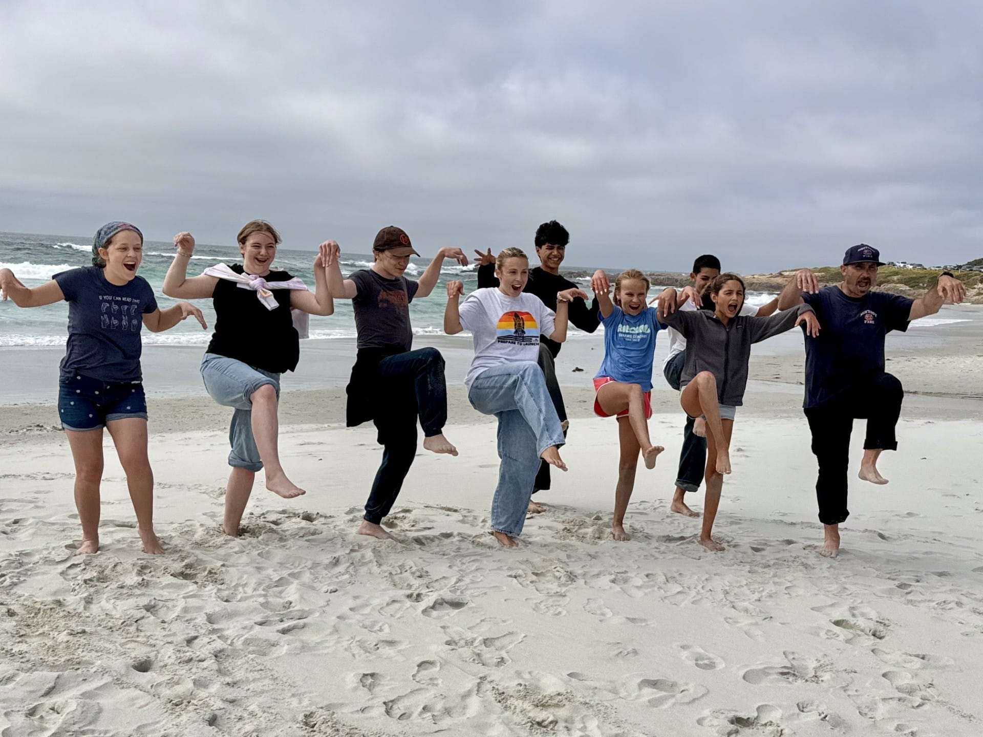 happy group of teenagers at the beach