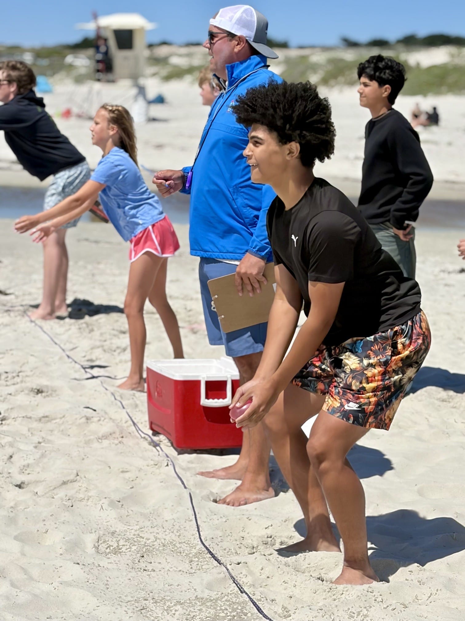 kids playing volleyball at the beach