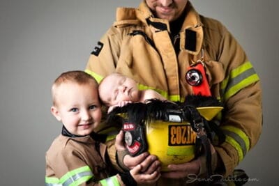 firefighter with two kids in uniform