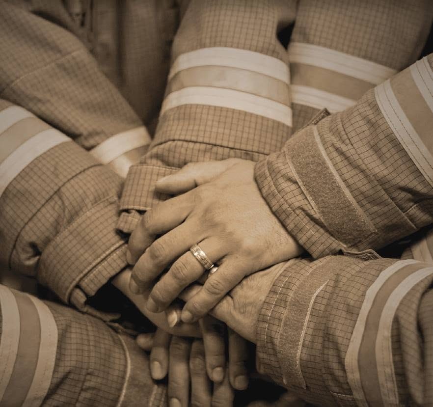 firefighters hands show unity